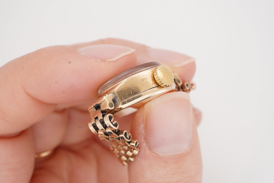 A lady's 1970's 9ct gold Rotary manual wind wrist watch, with Arabic dial, on a 9ct gold bracelet, case diameter 19mm, overall length 18cm, gross weight 15.4 grams.